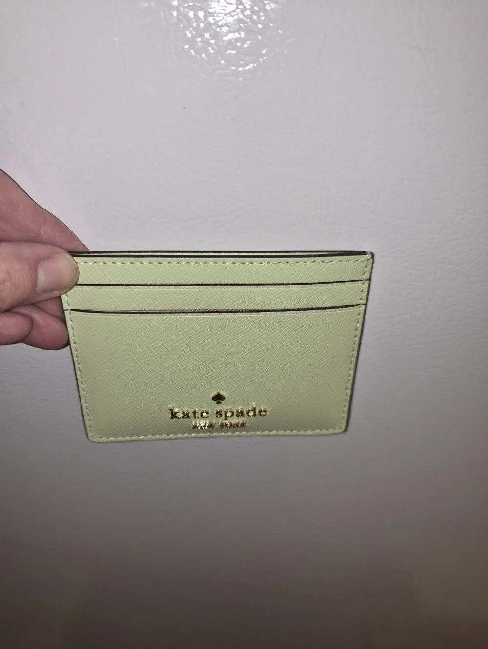kate spade lemon green card holder with gold logo